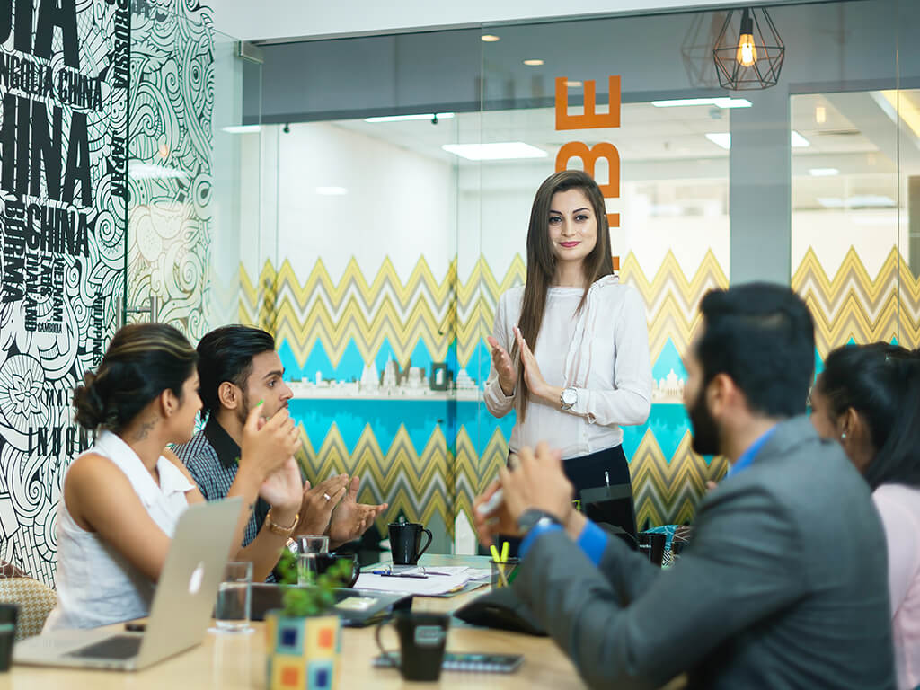 A team member presenting ideas to colleagues in a meeting room