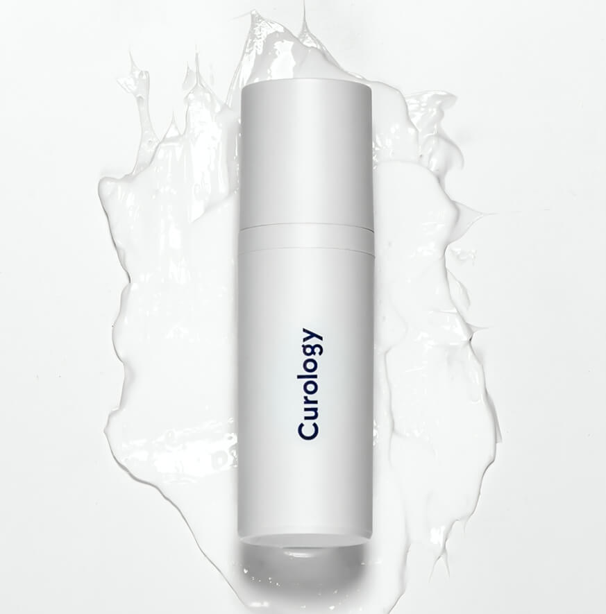 White skincare bottle on a splash of lotion
