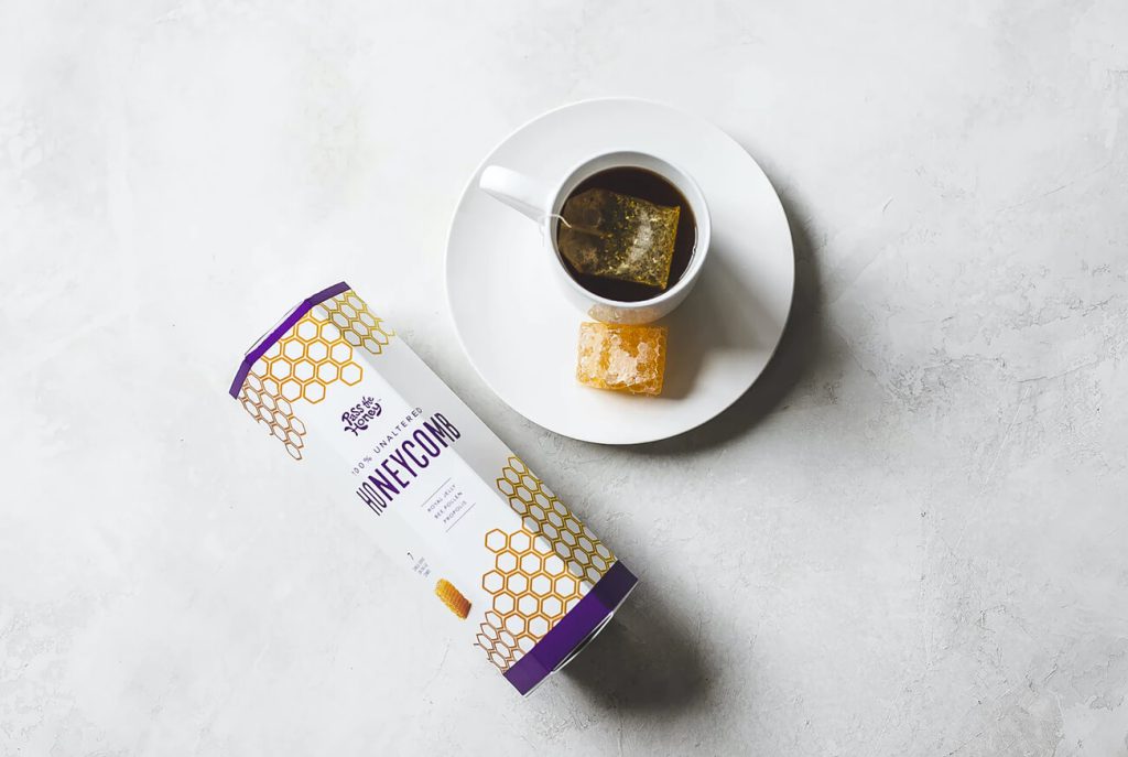 Tea packaging next to a cup of tea