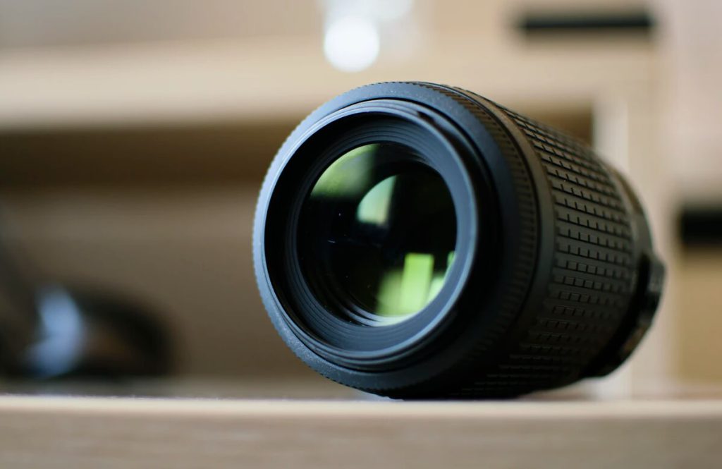 Camera lens on a wooden surface