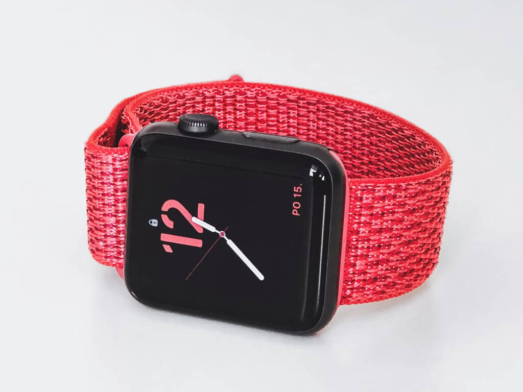Red smartwatch on a white surface